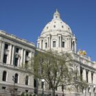 The exterior of a capitol building with trees.