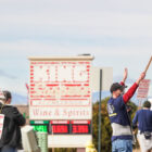 A man holds a sign saying “Please do not patronize King Sooper’s employees, on unfair labor practice strike, UFCW Local #7”.