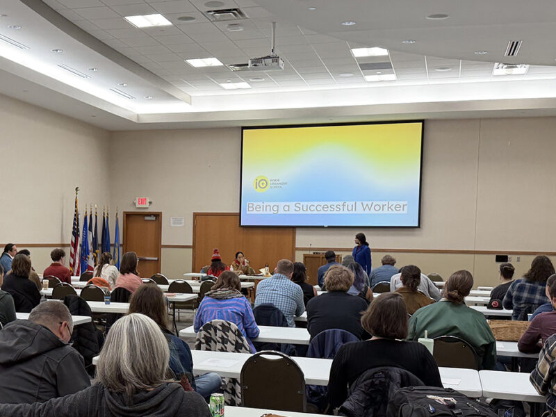 A group attends a talk titled "Being a Successful Worker" by Inside Organizer School.